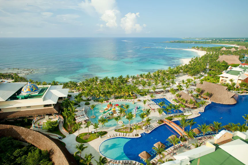 Barcelo Maya Palace premium all-inclusive resort with expansive pools, white sand beach, and grand architecture in the Riviera Maya.