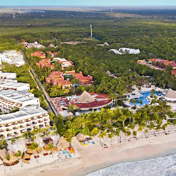 Catalonia Playa Maroma all-inclusive resort on Playa Maroma beach with turquoise waters, white sand, and tropical palm trees.