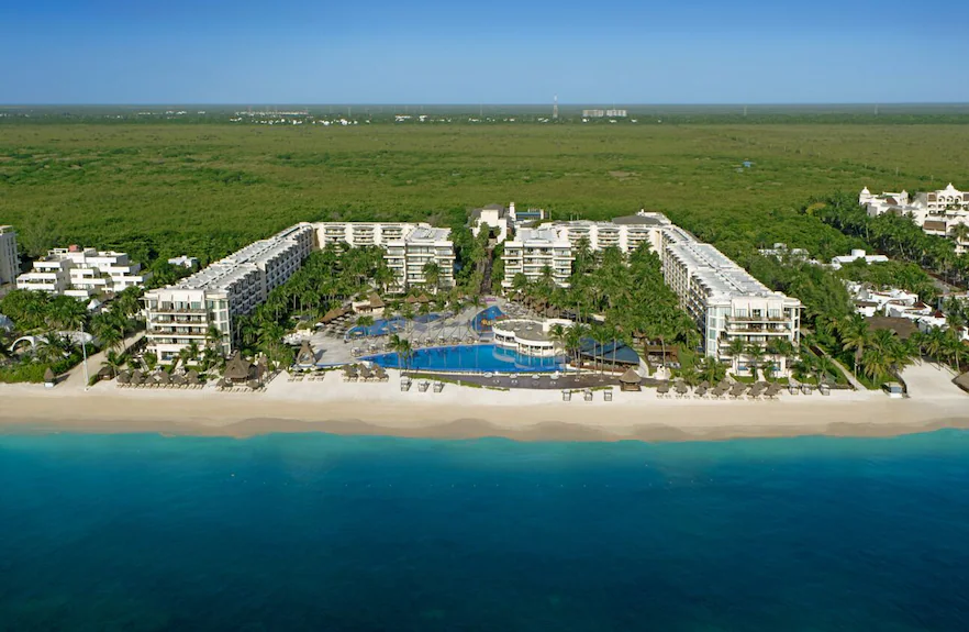 Dreams Riviera Cancun all-inclusive resort with white sand beach, tropical pools, lush gardens, and oceanfront setting in Puerto Morelos.