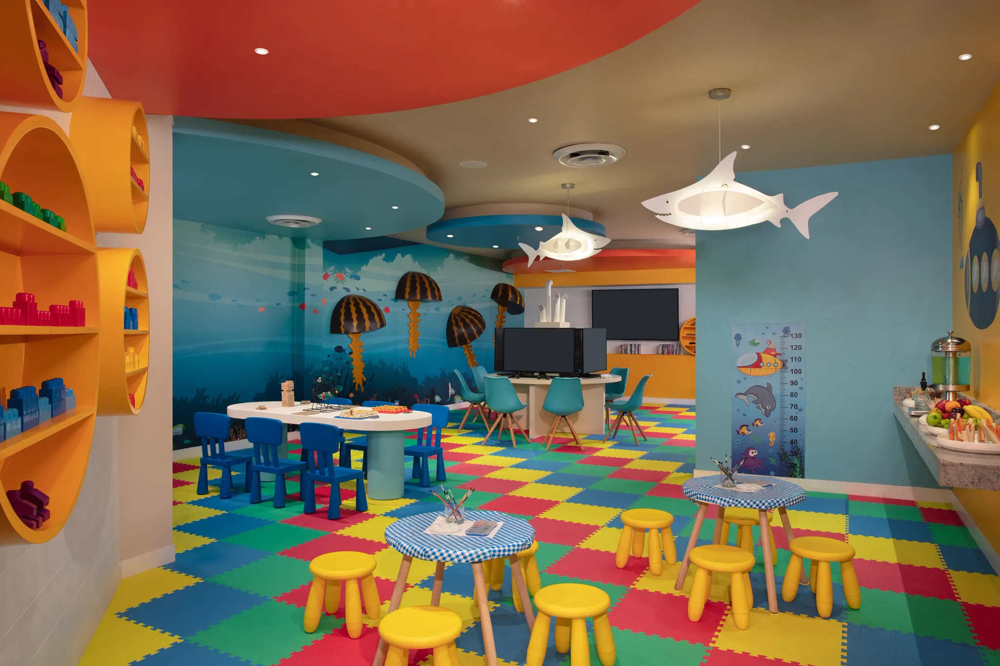 Colorful kids club playroom with crafts tables and ocean-themed decor at Dreams Aventuras Riviera Maya.