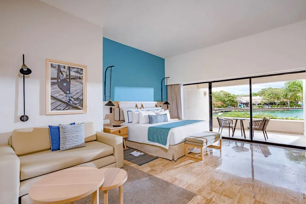 Preferred Club Family Room Marina View with king bed and private terrace overlooking the marina at Dreams Aventuras Riviera Maya.