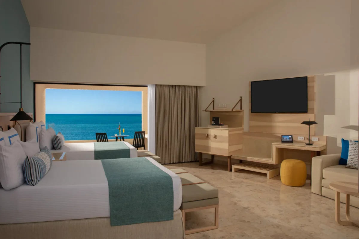 Preferred Club Family Room Ocean View with two double beds and balcony overlooking the Caribbean at Dreams Aventuras Riviera Maya.