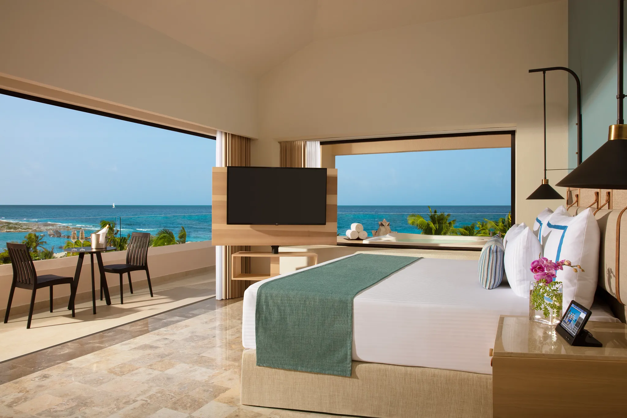 Preferred Club Honeymoon Ocean View suite with king bed and balcony at Dreams Aventuras Riviera Maya.