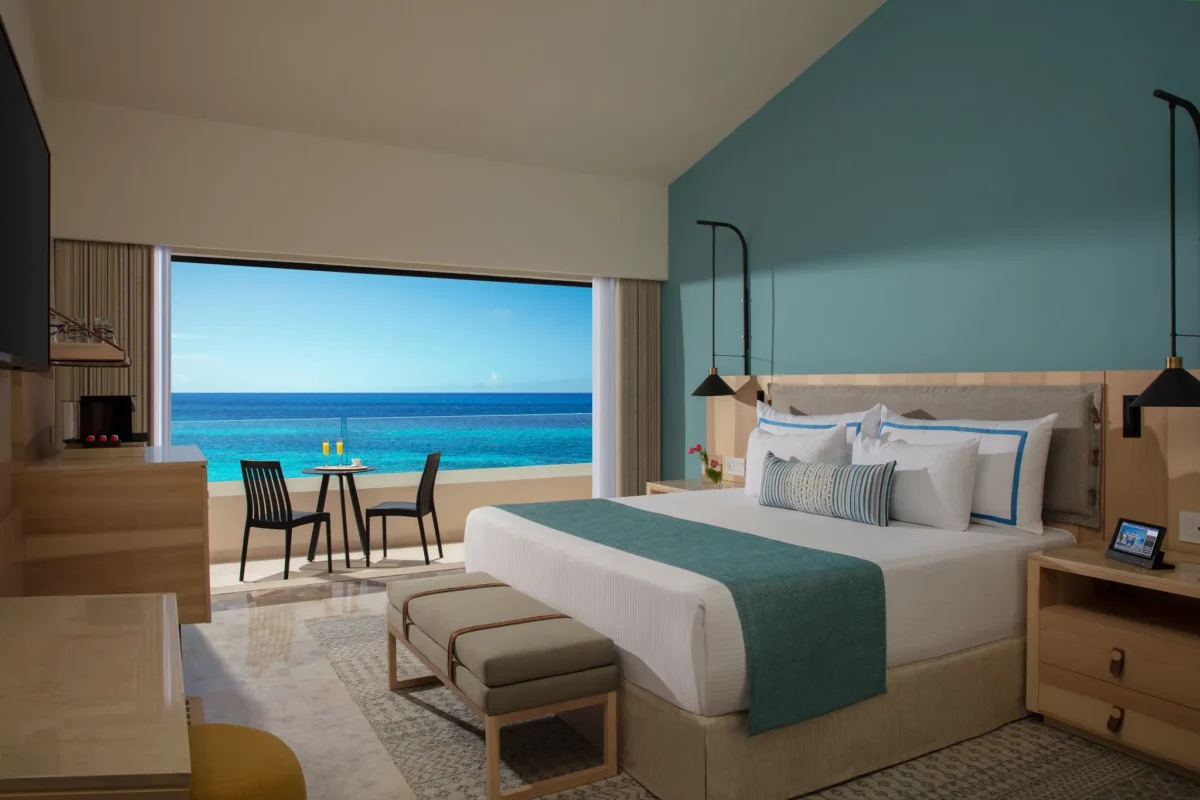 Preferred Club Master Suite Ocean View with king bed and private balcony overlooking the Caribbean Sea at Dreams Aventuras Riviera Maya.