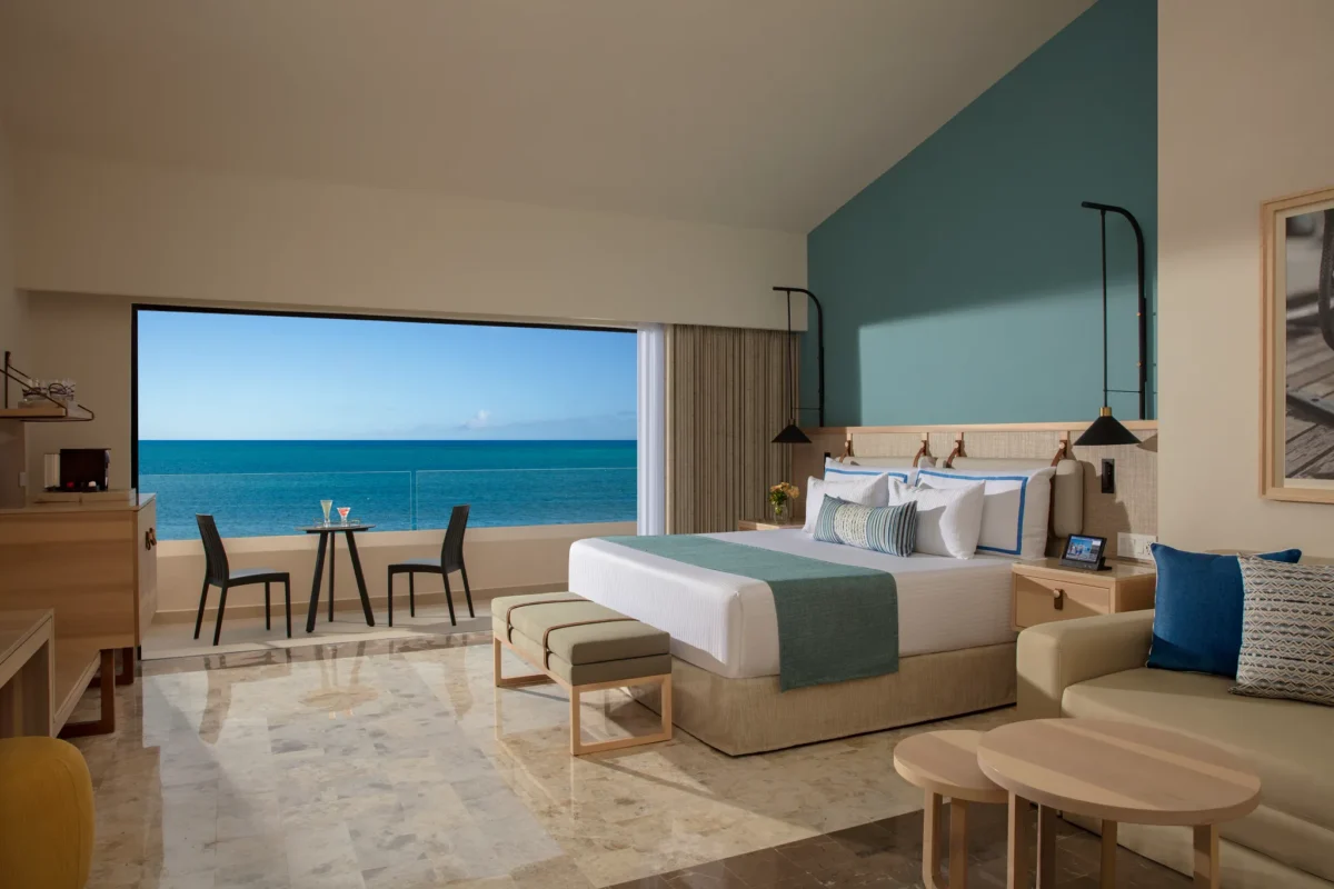 Preferred Club Ocean View room with king bed and private balcony overlooking the Caribbean Sea at Dreams Aventuras Riviera Maya.