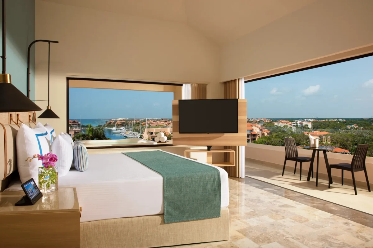 Preferred Club Premium Suite Marina View with king bed and balcony at Dreams Aventuras Riviera Maya.