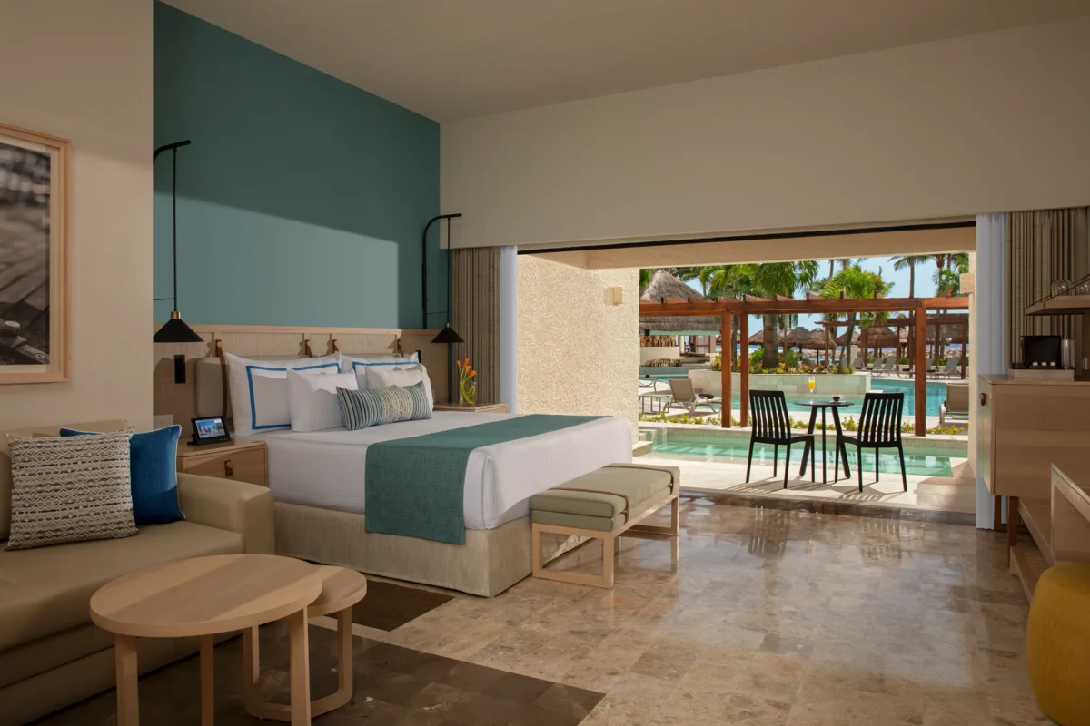 Preferred Club Swim Out room with king bed and direct pool access at Dreams Aventuras Riviera Maya.