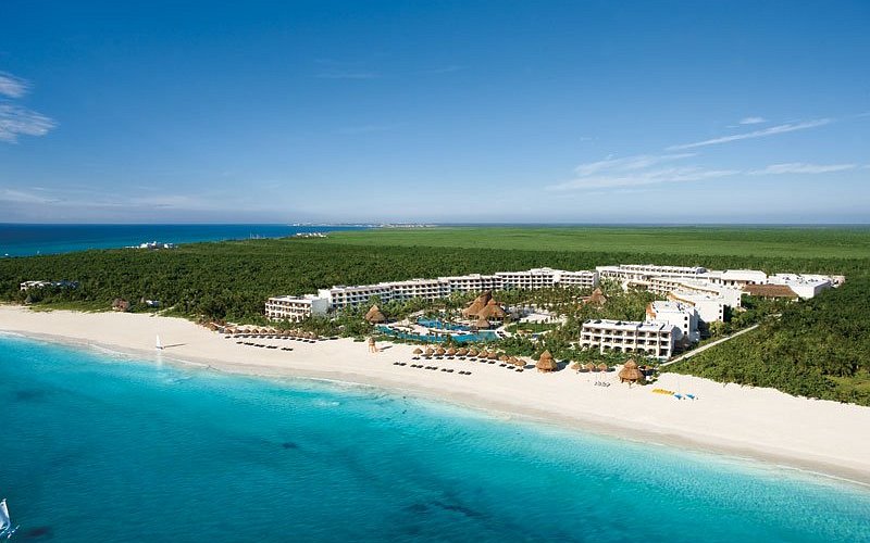 Secrets Riviera Cancun adults-only all-inclusive resort with oceanfront infinity pools, elegant suites, and romantic atmosphere near Puerto Morelos.