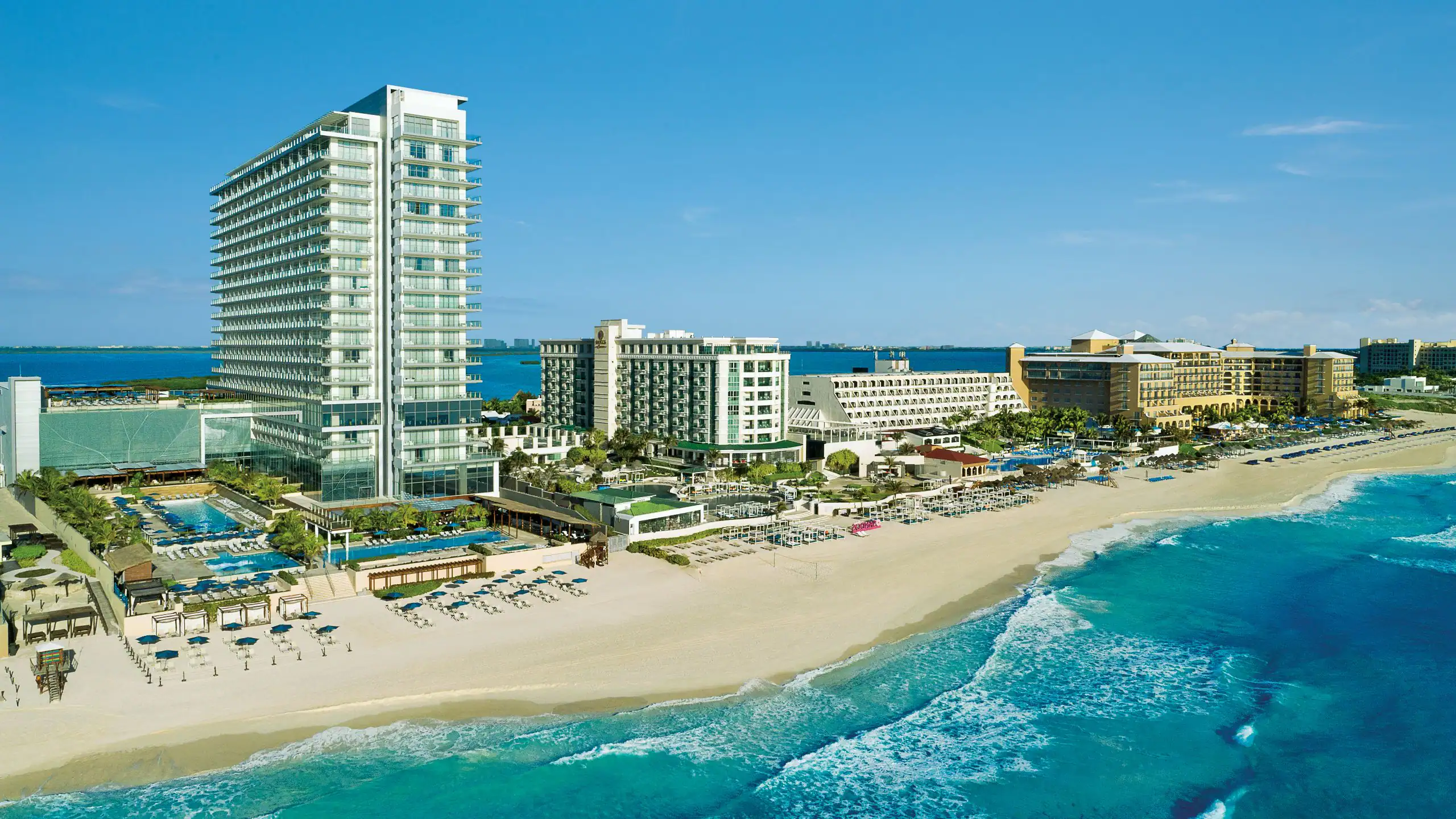 Secrets The Vine Cancun adults-only all-inclusive resort with sleek modern architecture, oceanfront infinity pools, and Hotel Zone location.
