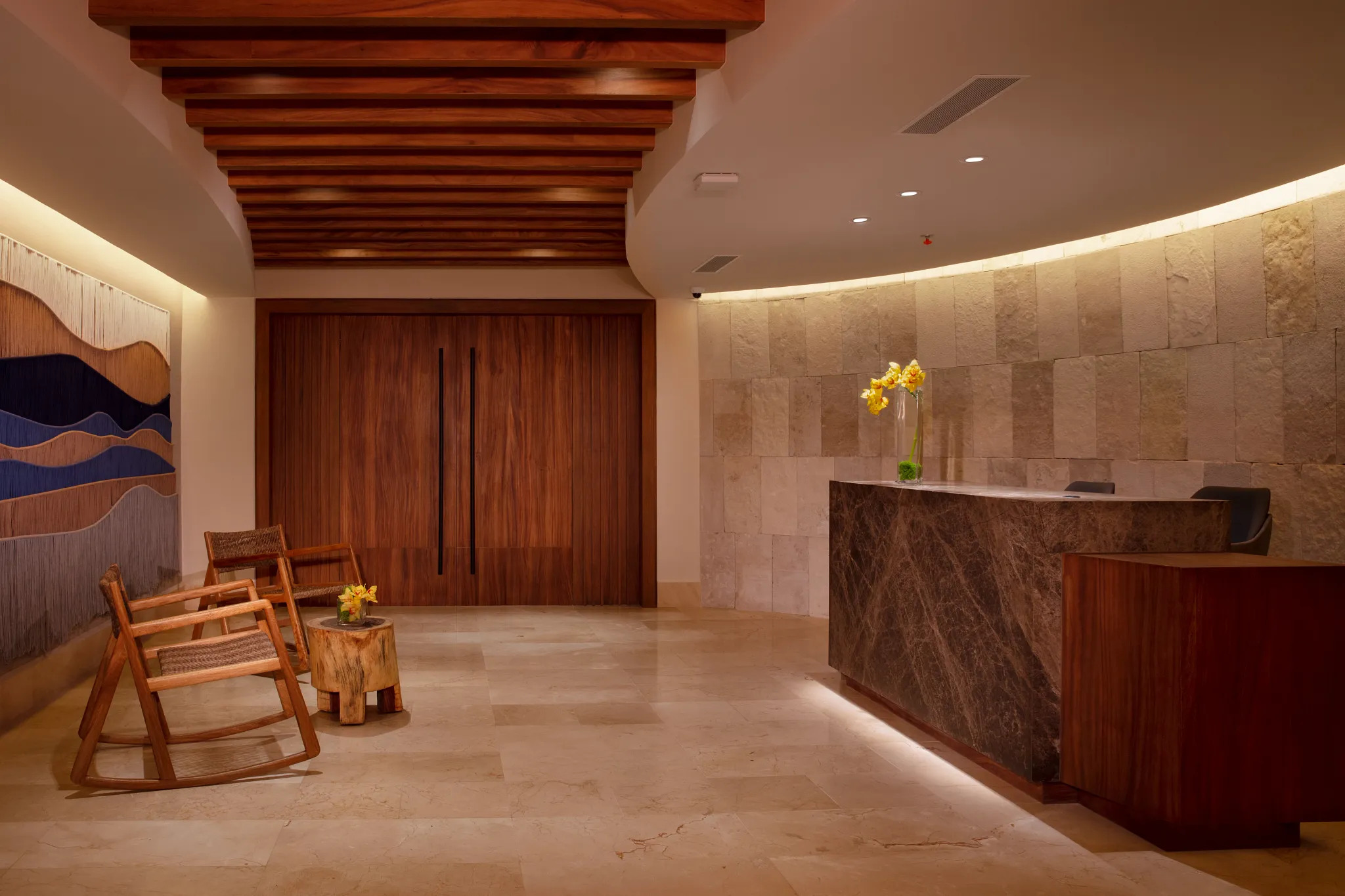 Spa reception desk with modern design and seating area at Dreams Aventuras Riviera Maya.