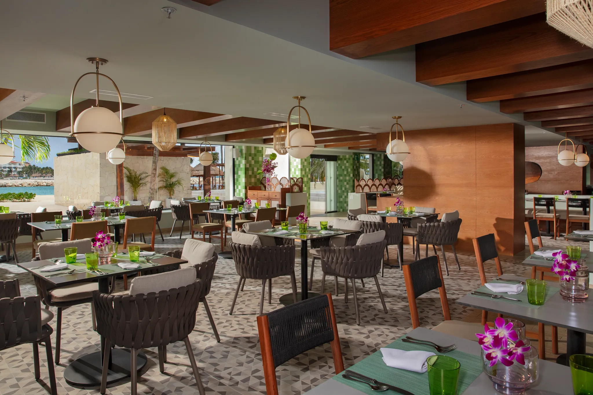 World Café buffet restaurant at Dreams Aventuras Riviera Maya featuring international cuisine stations, modern dining space, and casual family-friendly atmosphere.